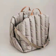 Padded dog car seat that converts into a travel bed and portable carrier for safe, stylish journeys