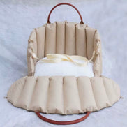 Padded dog car seat that converts into a travel bed and portable carrier for safe, stylish journeys