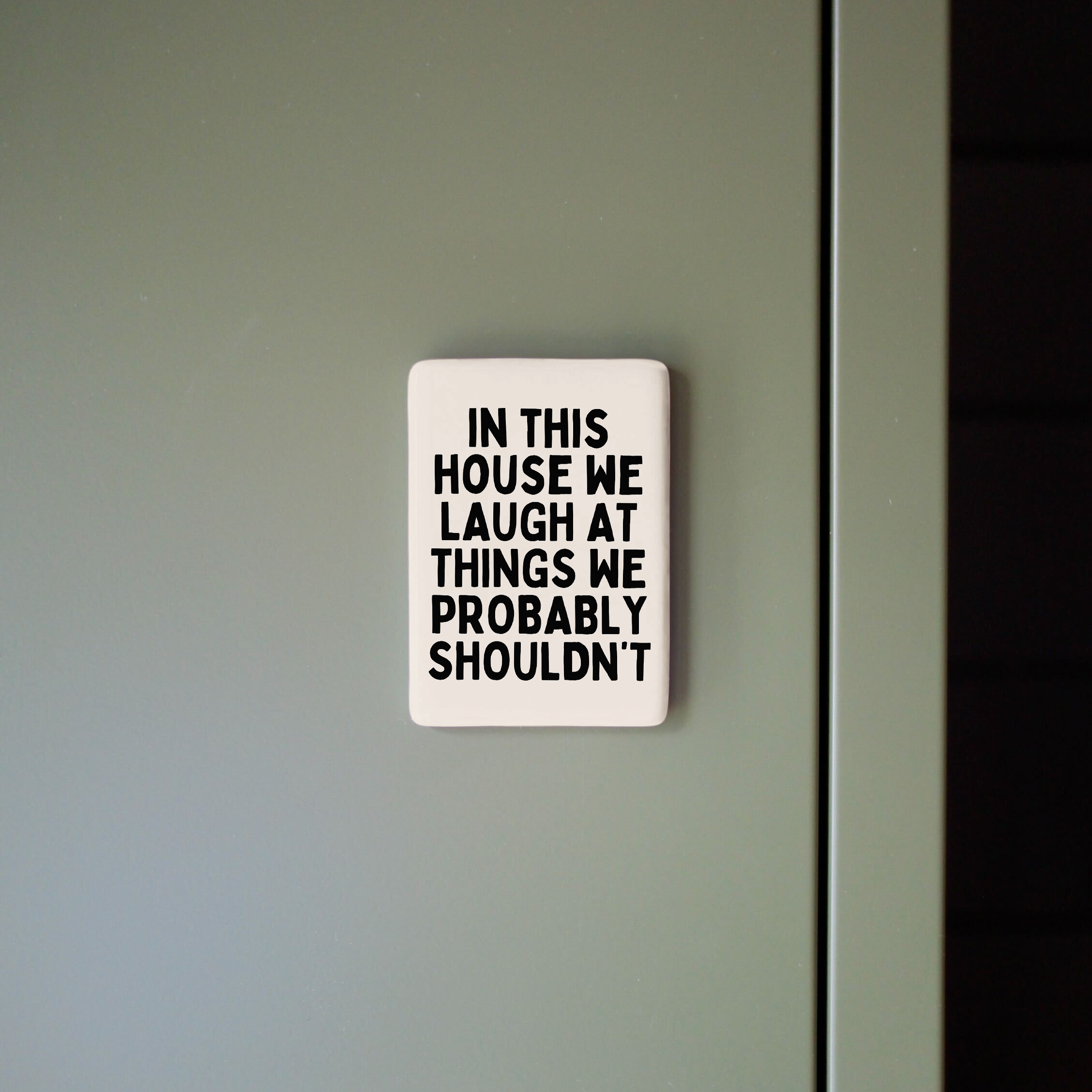 In This House We Laugh At Things We Probably Shouldn't | Ceramic Magnet: Black & Cream